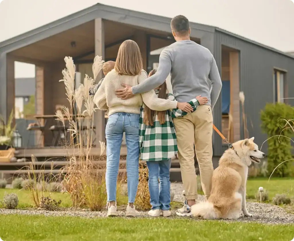 Family standing and watching a house - home insurance